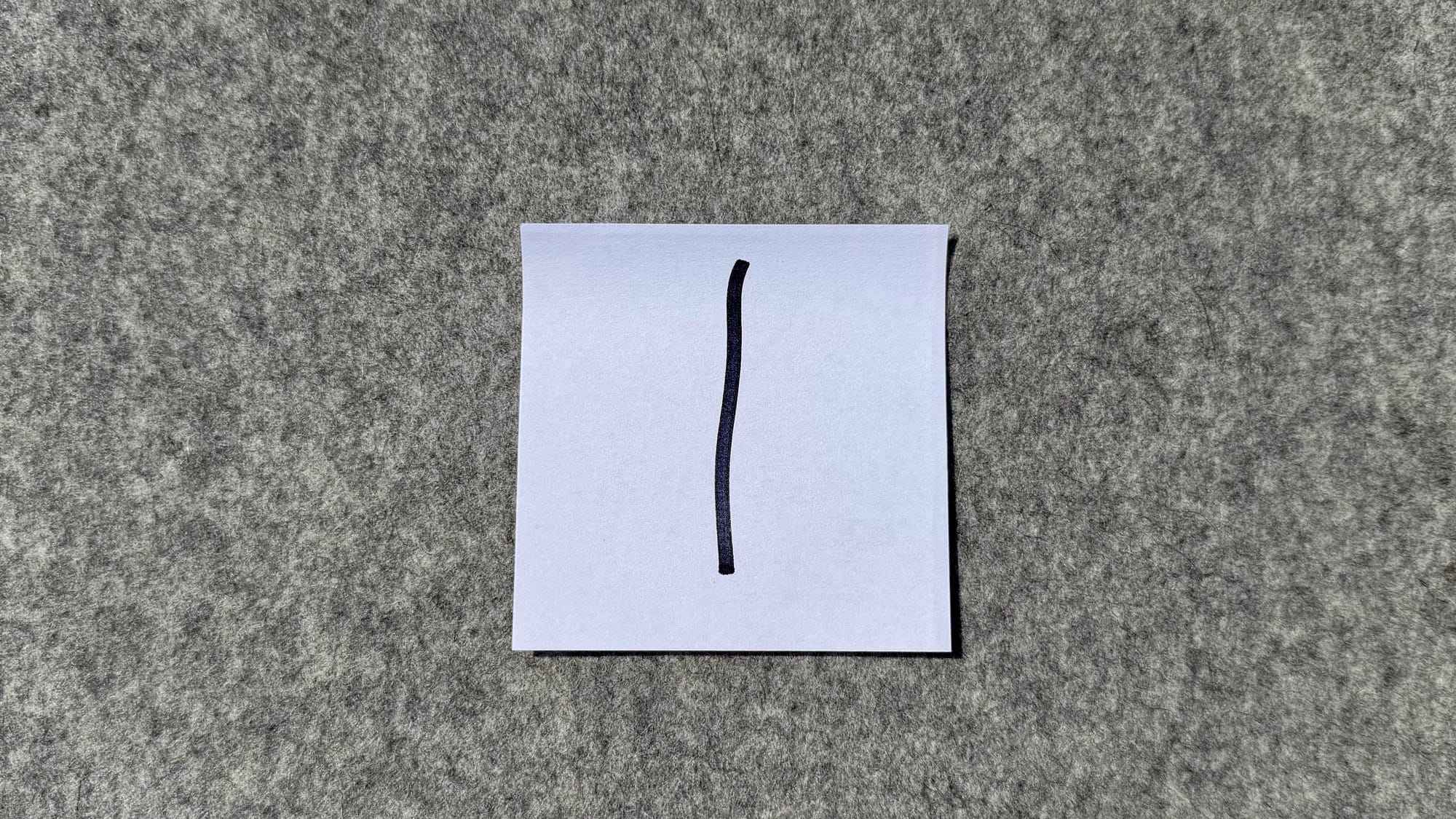 A square piece of paper with a single line drawn down the middle.